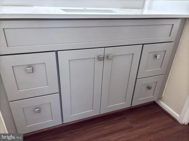 a view of a closet with wooden floor
