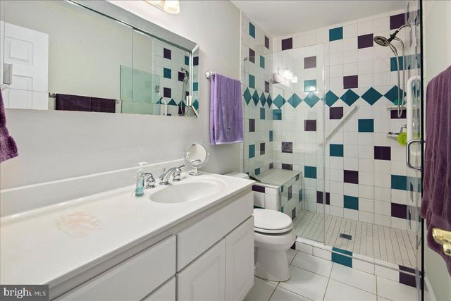 a bathroom with a sink a toilet and shower curtain