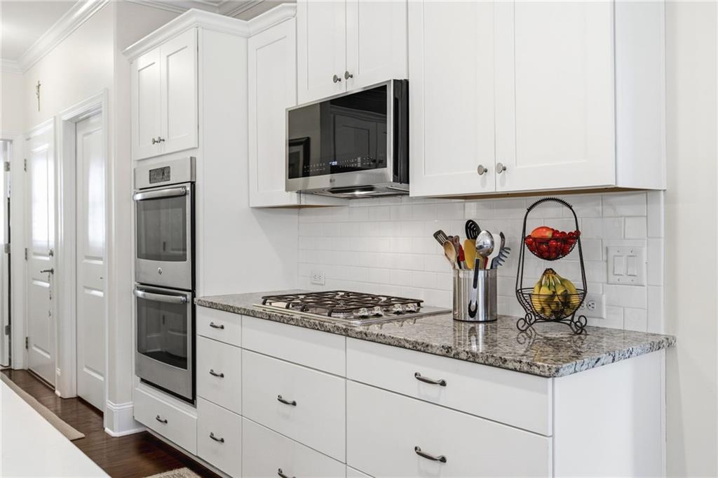 91 Bellwind Lane Dallas, GA 30132 - Photo 14 of 44 a kitchen with stainless steel appliances granite countertop a stove a microwave and cabinets