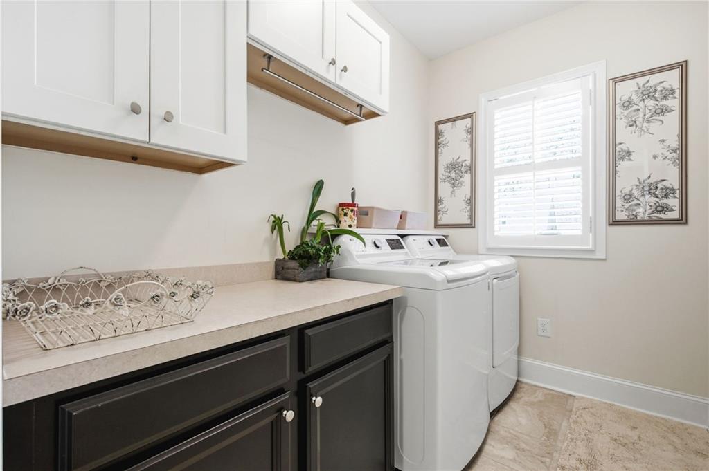 91 Bellwind Lane Dallas, GA 30132 - Photo 21 of 44 a utility room with cabinets washer and dryer