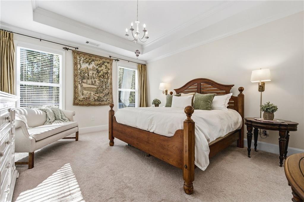 91 Bellwind Lane Dallas, GA 30132 - Photo 22 of 44 a spacious bedroom with a bed and a chandelier