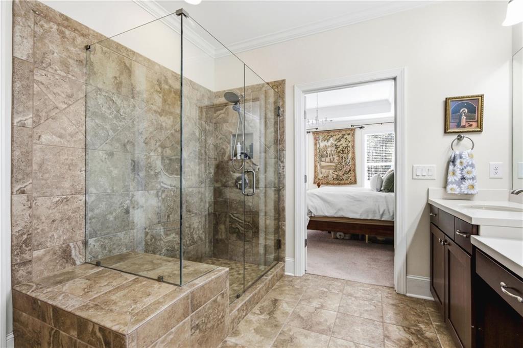 91 Bellwind Lane Dallas, GA 30132 - Photo 25 of 44 a en suite bathroom with a sink a mirror and a shower