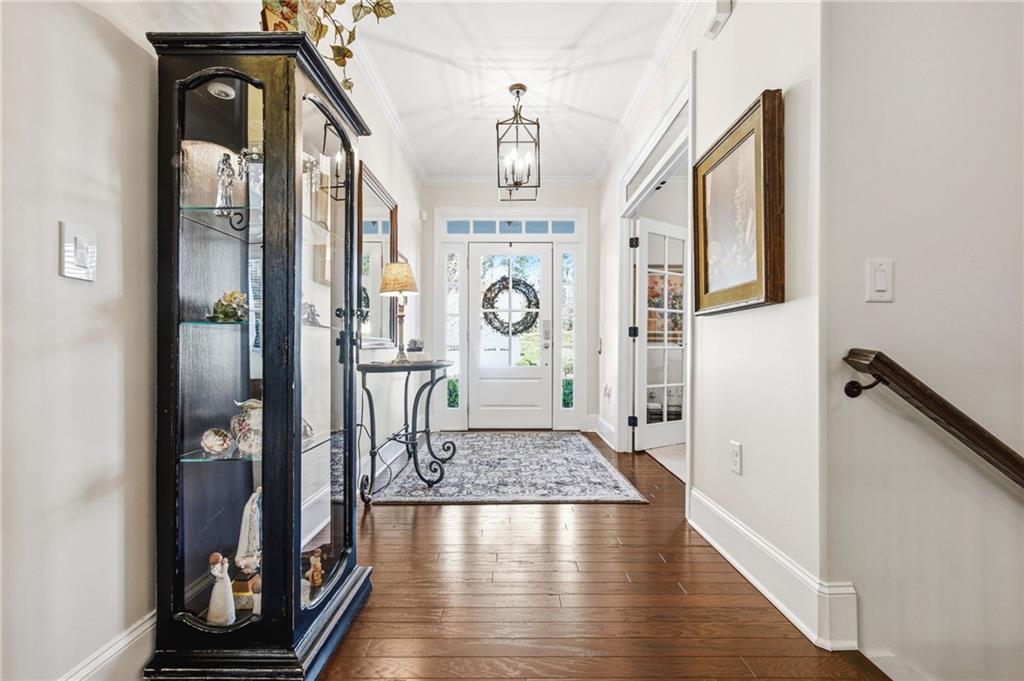 91 Bellwind Lane Dallas, GA 30132 - Photo 3 of 44 a view of a hallway with wooden floor and staircase