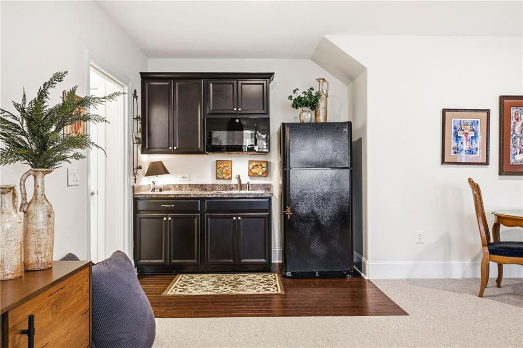 91 Bellwind Lane Dallas, GA 30132 - Photo 32 of 44 a living room with stainless steel appliances kitchen island granite countertop furniture a rug and a window