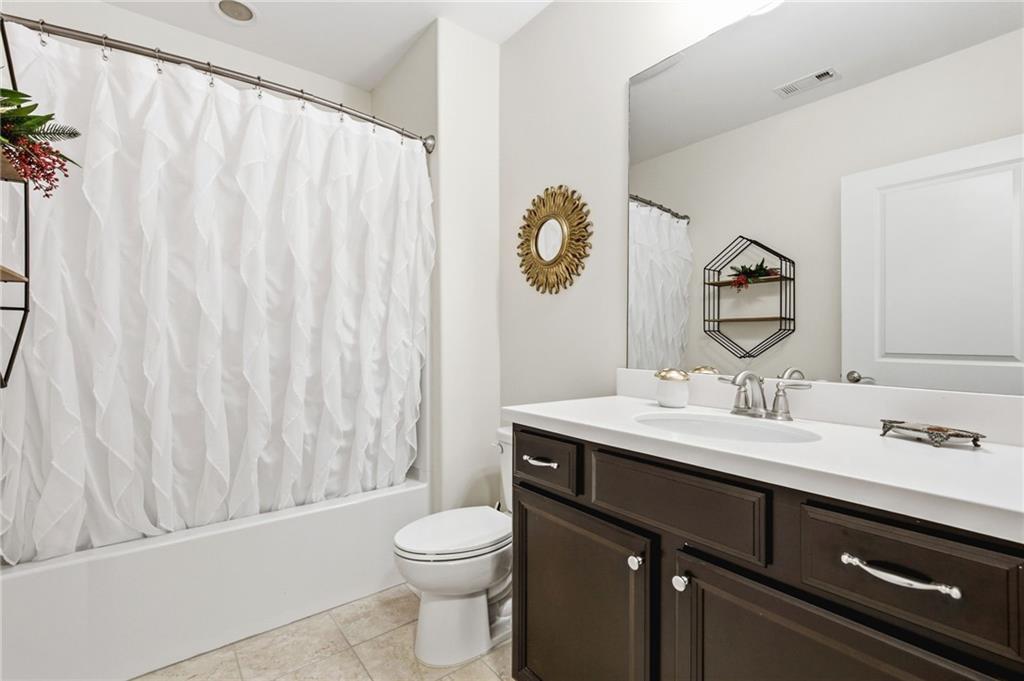 91 Bellwind Lane Dallas, GA 30132 - Photo 34 of 44 a bathroom with a granite countertop sink a toilet and a mirror