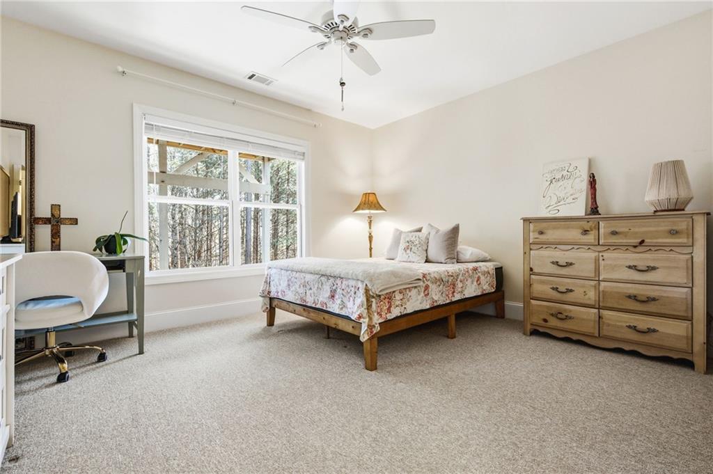 91 Bellwind Lane Dallas, GA 30132 - Photo 35 of 44 a bedroom with a bed a chair and a large window