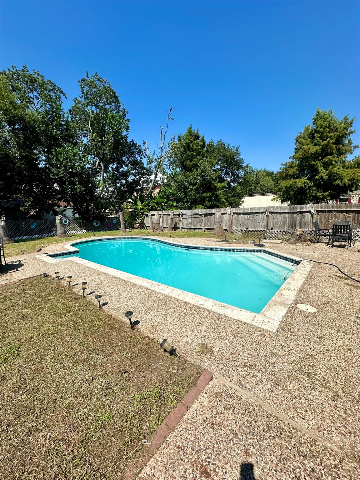 236 3rd Street San Leon, TX 77539 - Photo 3 of 18 a view of a swimming pool with an outdoor space and seating area