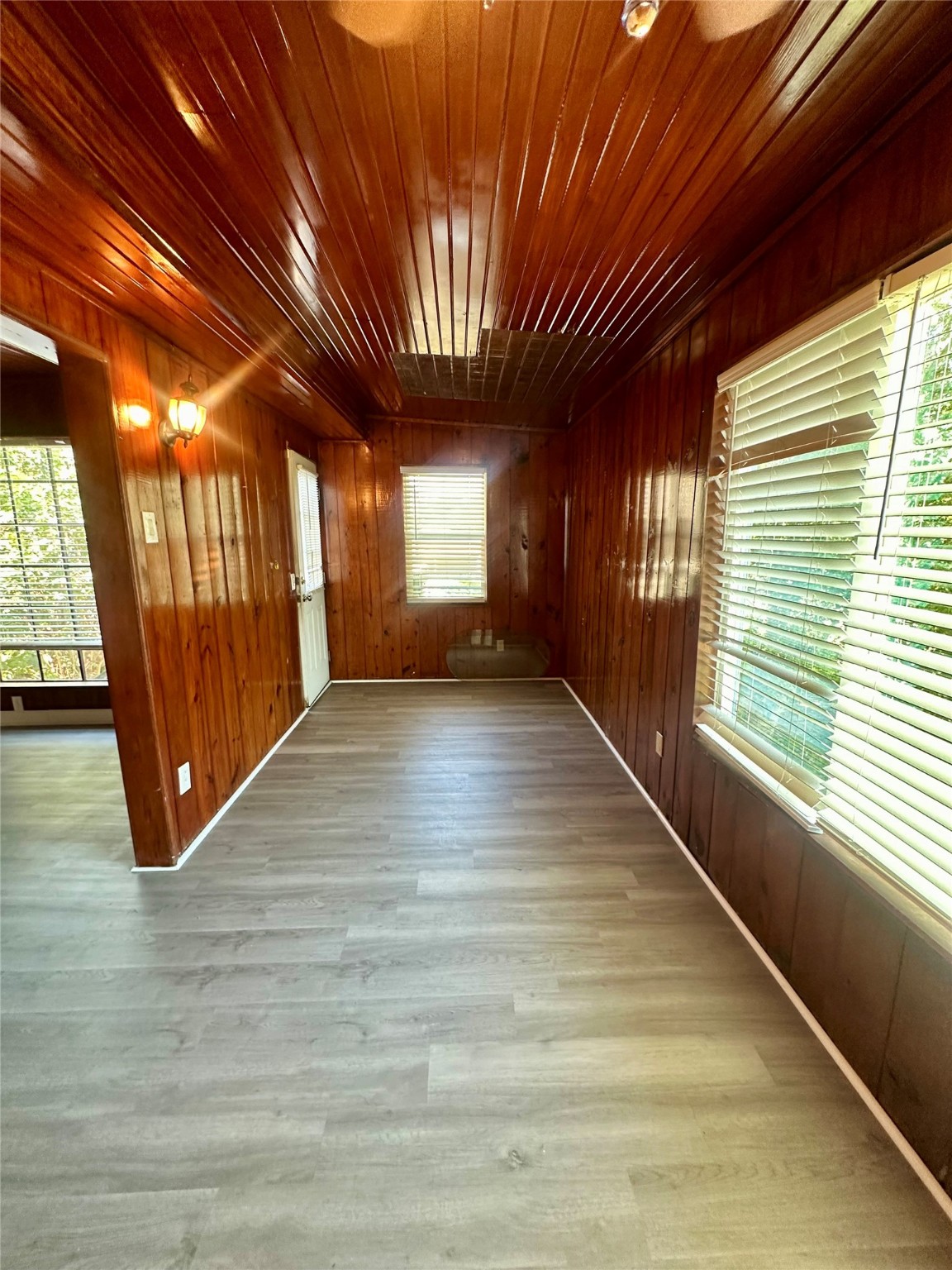236 3rd Street San Leon, TX 77539 - Photo 8 of 18 a view of an empty room with wooden floor and a window