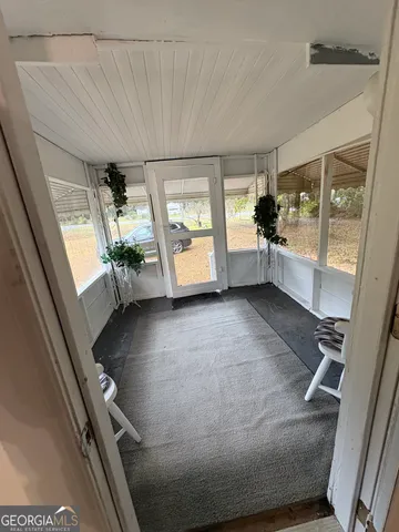 a living room with furniture a dining table and a chandelier