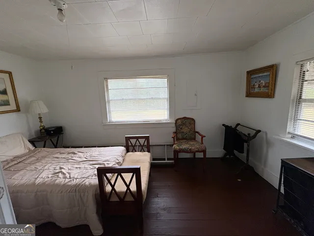 a bedroom with a bed and a chair