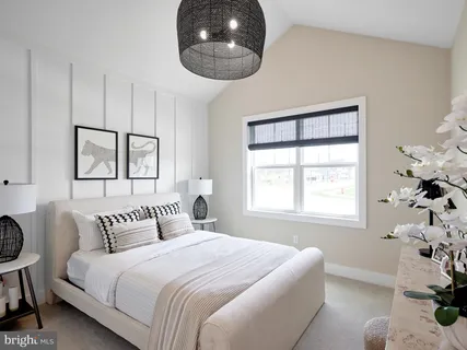 a bedroom with a bed dresser and a window