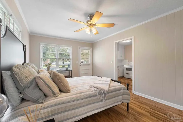 a bedroom with a bed and wooden floor