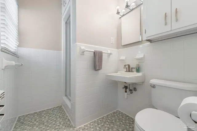 a bathroom with a granite countertop sink and a bathtub