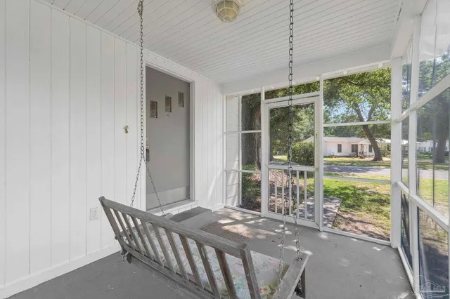 a bedroom with furniture and large windows