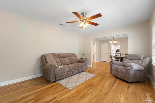 a view of a dining room with furniture wooden floor and chandelier