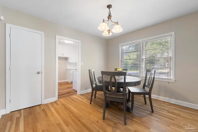 a view of a dining room with furniture and wooden floor