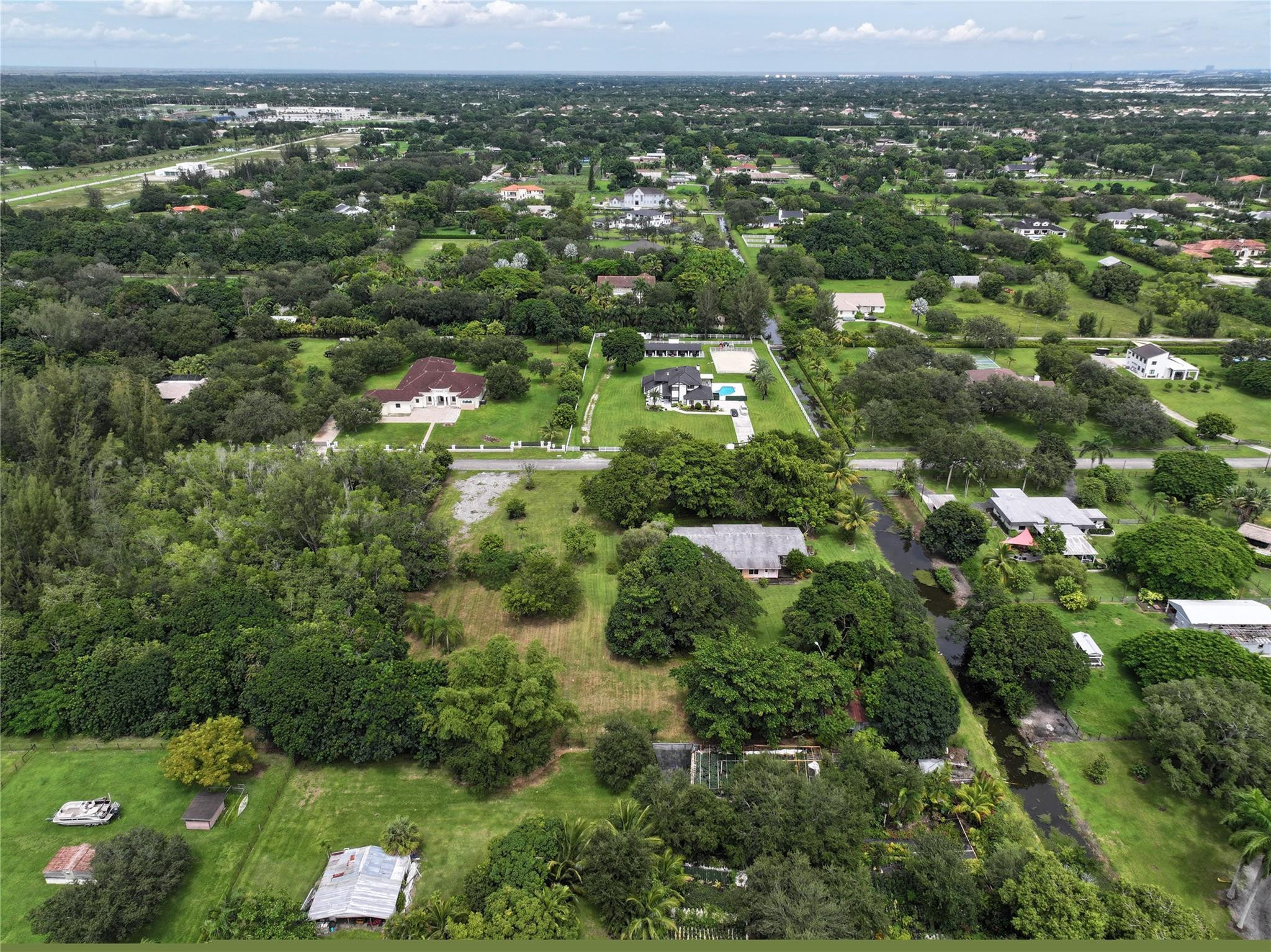 18100 Southwest 55th Street Southwest Ranches, FL 33331 - Photo 11 of 16 an aerial view of residential houses with outdoor space and trees