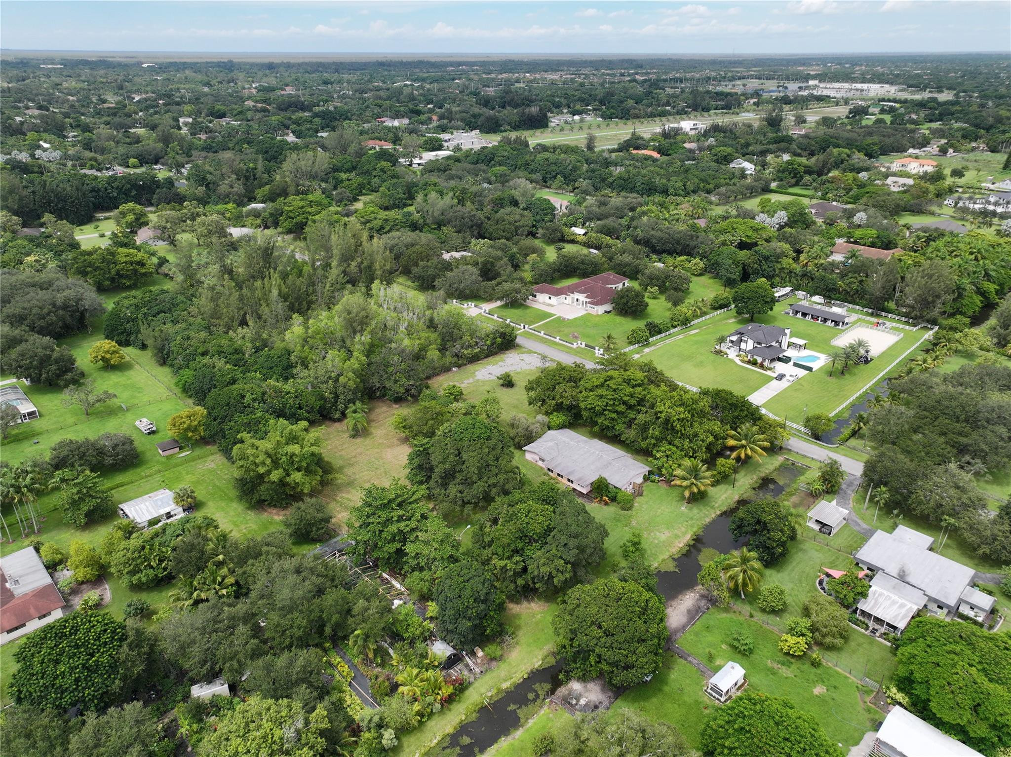18100 Southwest 55th Street Southwest Ranches, FL 33331 - Photo 7 of 16 an aerial view of residential houses with outdoor space and trees
