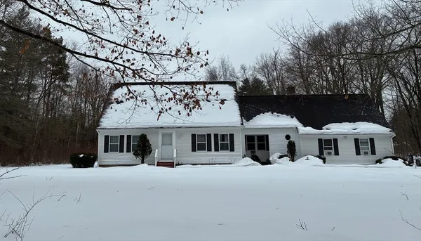 a group of people sitting in front of house