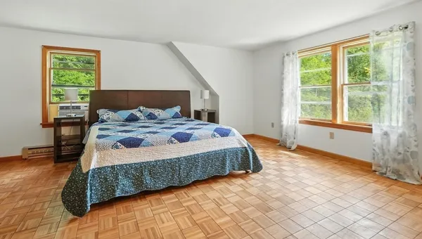 a bedroom with a bed and a window