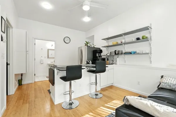 a kitchen with a sink cabinets and living room view