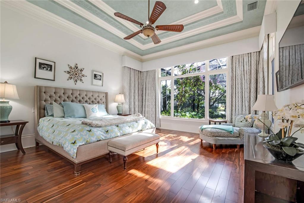 2220 Miramonte Court Naples, FL 34105 - Photo 12 of 35 a bedroom with a bed a couch and a large window