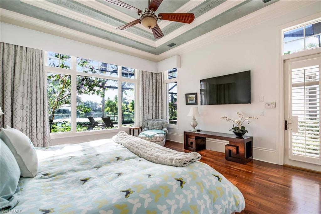 2220 Miramonte Court Naples, FL 34105 - Photo 14 of 35 a bedroom with a bed and a flat screen tv