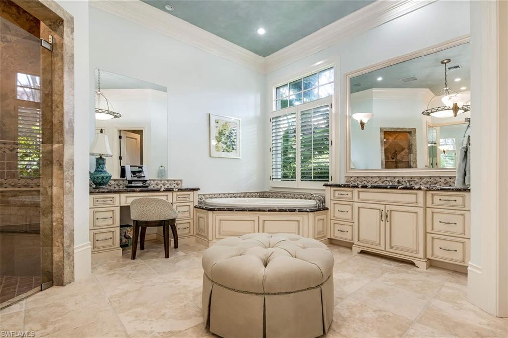 2220 Miramonte Court Naples, FL 34105 - Photo 16 of 35 a bathroom with a sink and a large mirror