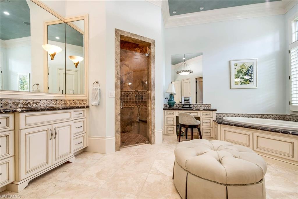 2220 Miramonte Court Naples, FL 34105 - Photo 17 of 35 a spacious bathroom with a granite countertop sink and a mirror