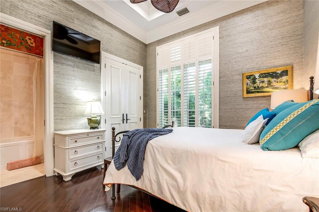 2220 Miramonte Court Naples, FL 34105 - Photo 19 of 35 a bedroom with a bed and a window