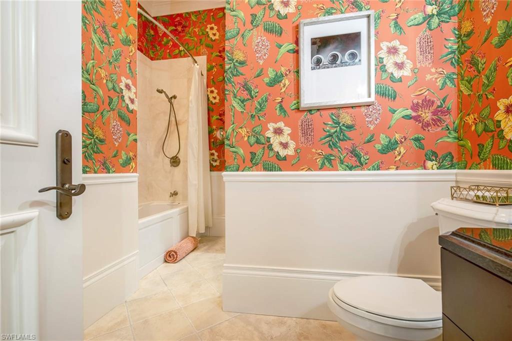 2220 Miramonte Court Naples, FL 34105 - Photo 21 of 35 a bathroom with a toilet and a shower curtain