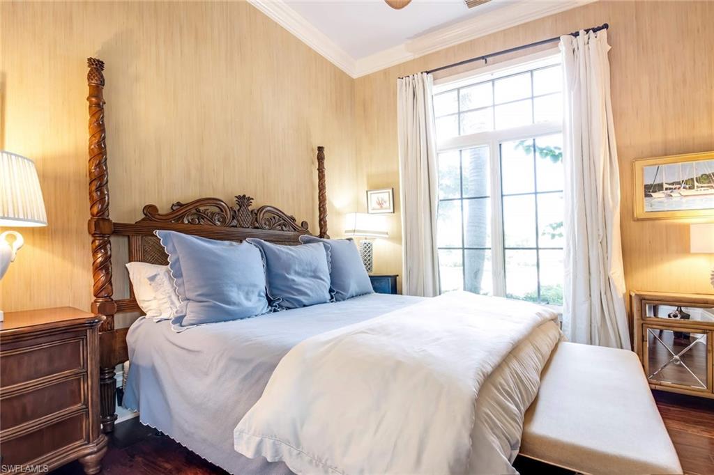 2220 Miramonte Court Naples, FL 34105 - Photo 22 of 35 a large bed sitting in a bedroom next to a window