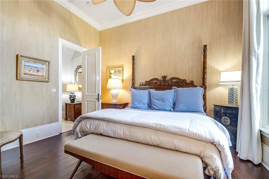 2220 Miramonte Court Naples, FL 34105 - Photo 23 of 35 a bedroom with a bed and wooden floor