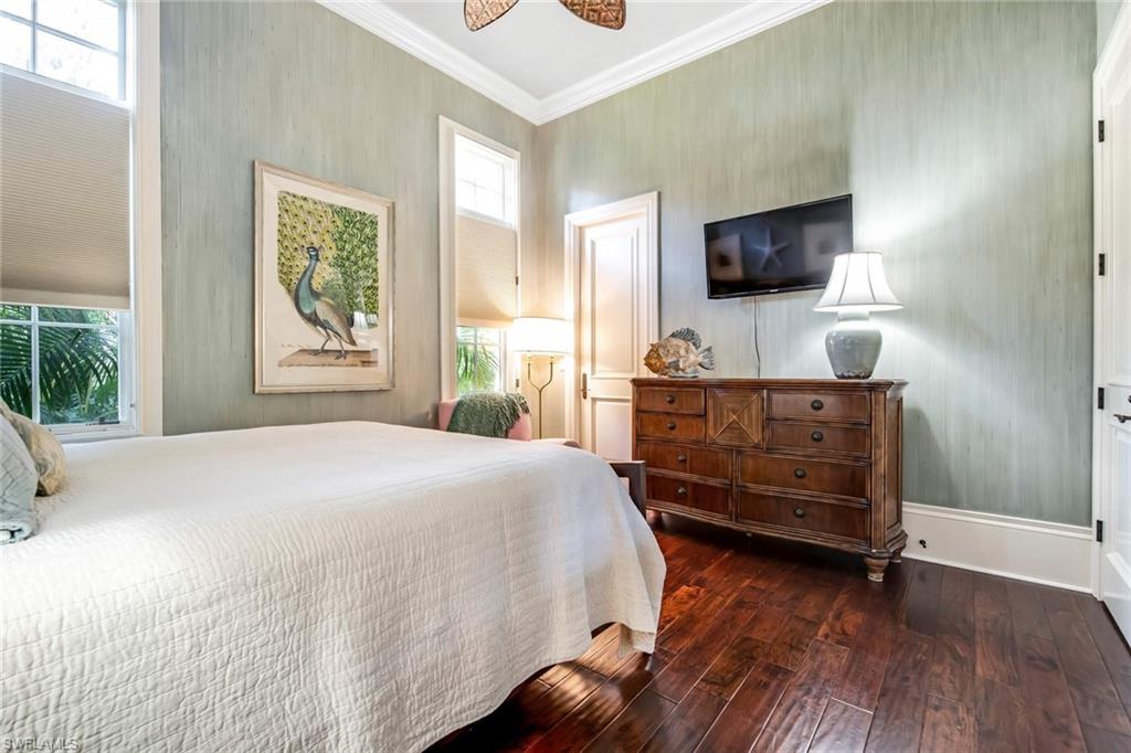 2220 Miramonte Court Naples, FL 34105 - Photo 25 of 35 a bedroom with a bed and a flat screen tv