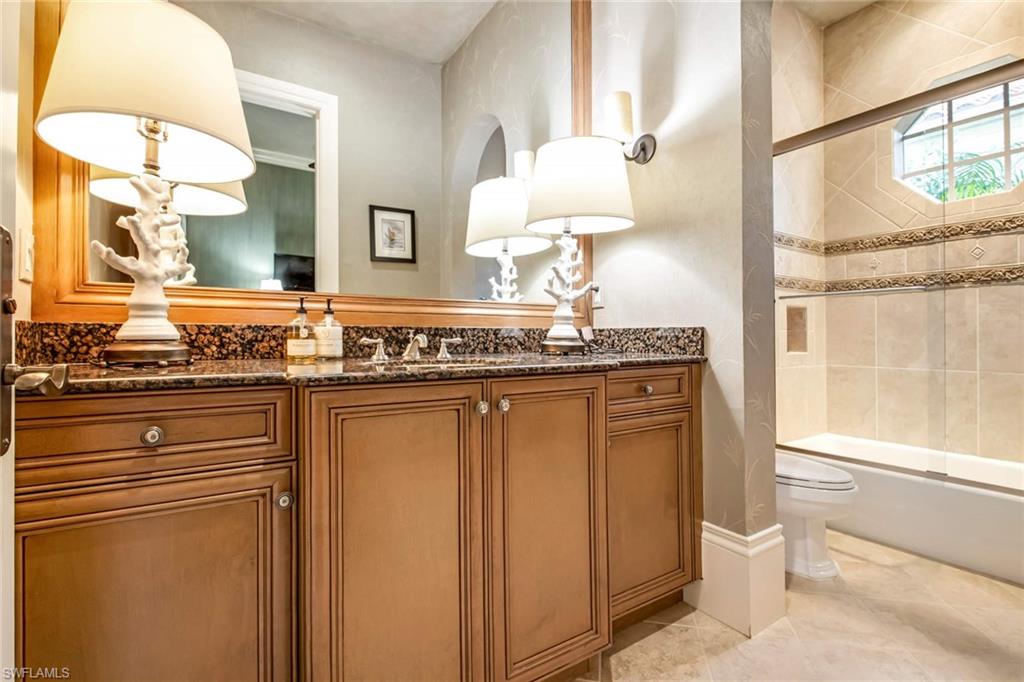 2220 Miramonte Court Naples, FL 34105 - Photo 26 of 35 a bathroom with a granite countertop sink and a mirror