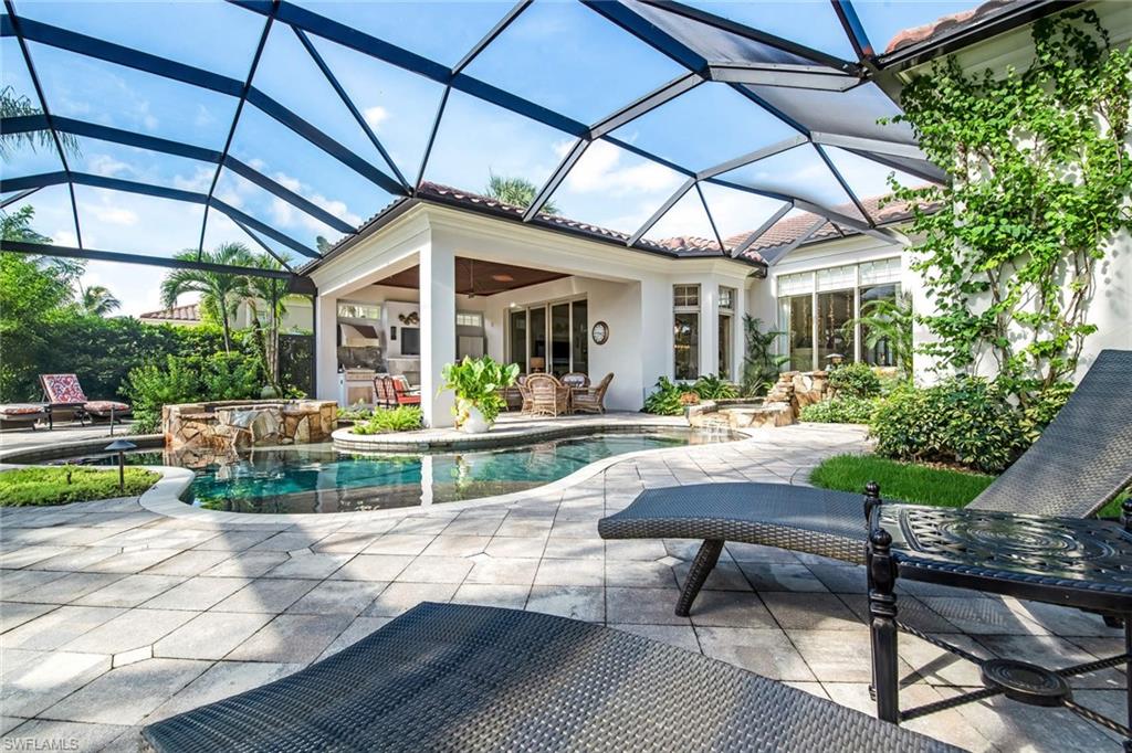 2220 Miramonte Court Naples, FL 34105 - Photo 28 of 35 a view of patio with a table and chairs under an umbrella