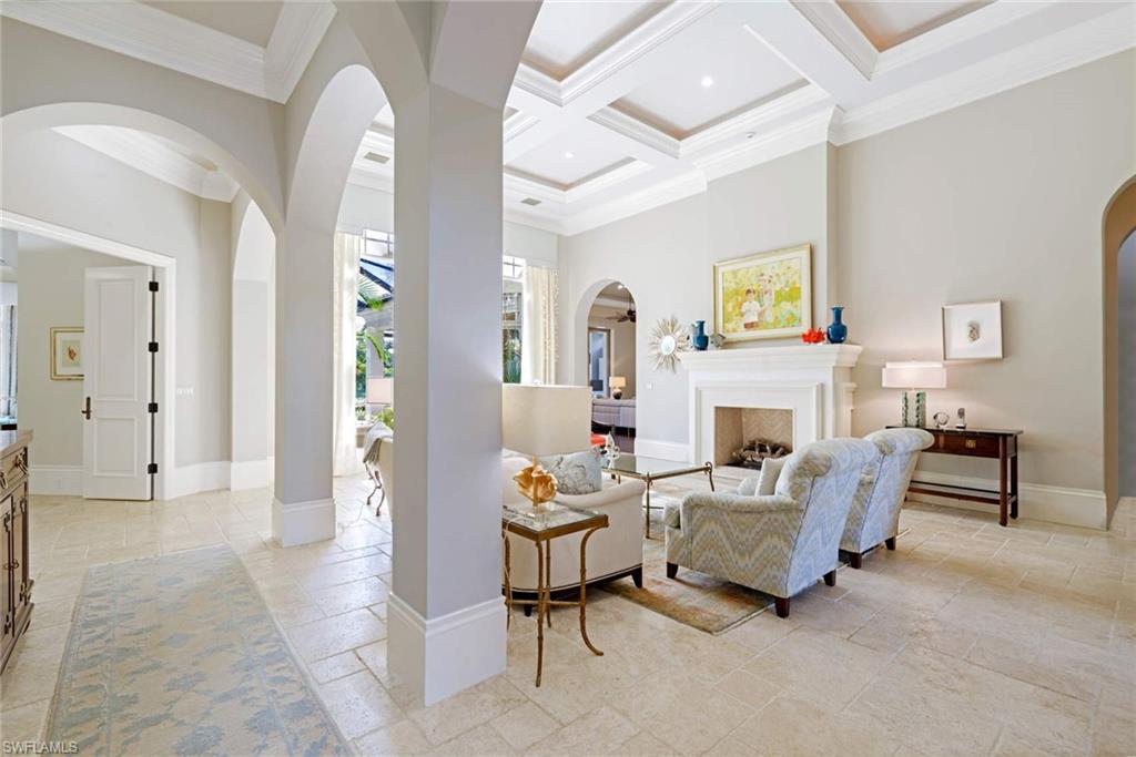 2220 Miramonte Court Naples, FL 34105 - Photo 4 of 35 a living room with furniture and a fireplace