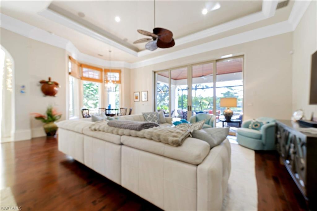 2220 Miramonte Court Naples, FL 34105 - Photo 7 of 35 a living room with furniture flat screen tv and windows