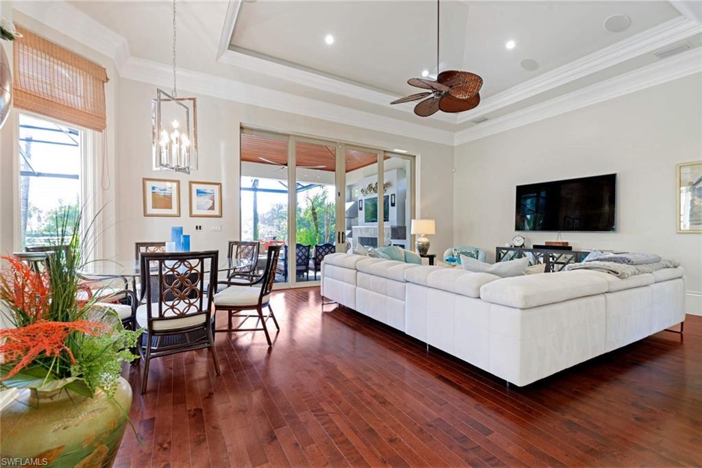 2220 Miramonte Court Naples, FL 34105 - Photo 8 of 35 a living room with furniture and a flat screen tv