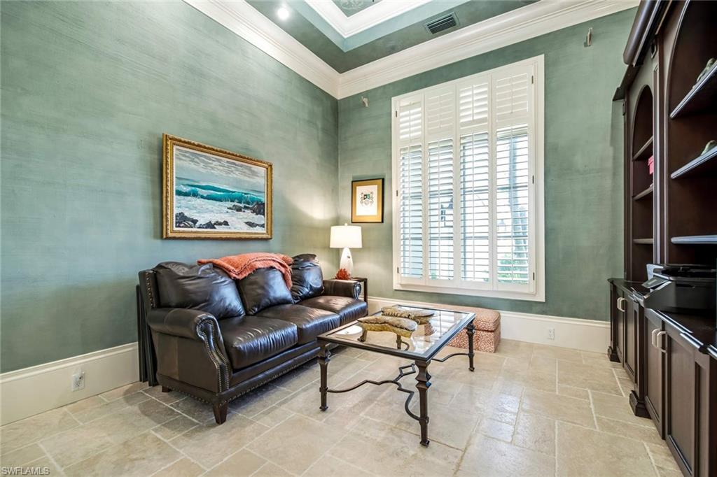 2220 Miramonte Court Naples, FL 34105 - Photo 9 of 35 a living room with furniture a flat screen tv and a window