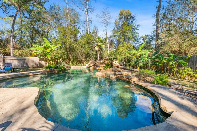 a view of a lake with lawn chairs and couches