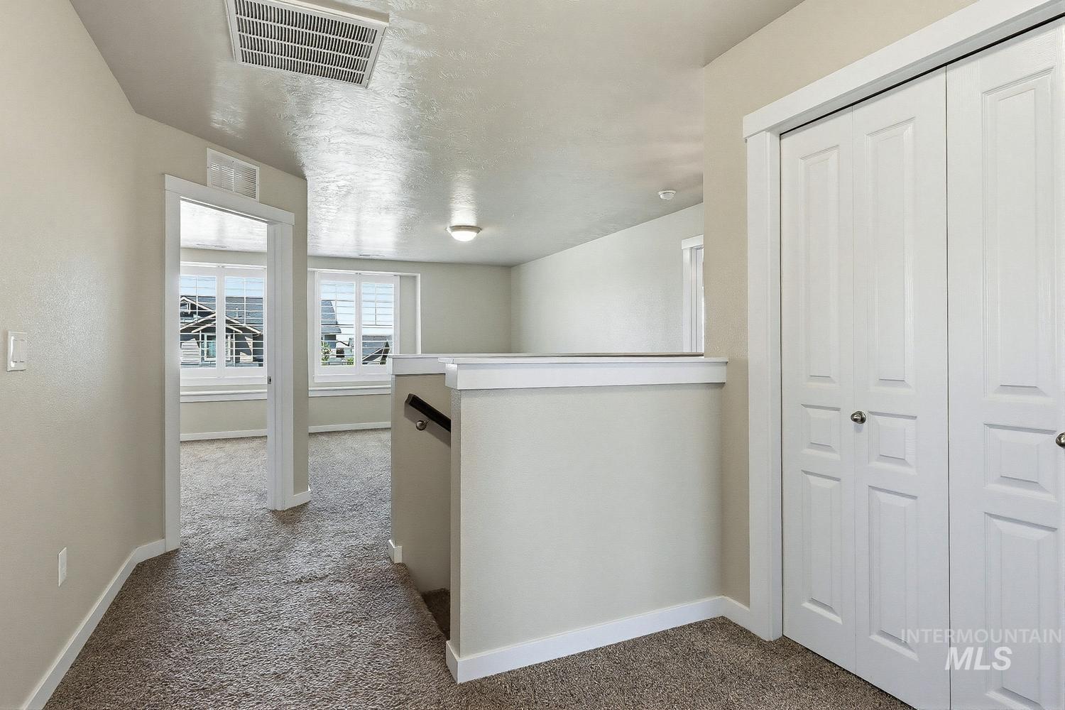 846 North Hidden View Way Star, ID 83669 - Photo 27 of 49 Carpeted upper-level hallway featuring a white banister and balusters