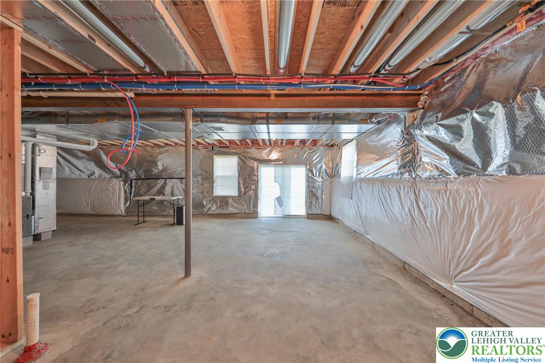 1105 Meco Road Easton, PA 18040 - Photo 38 of 100 An unfinished walk-out basement provides expansive potential for customized living spaces.