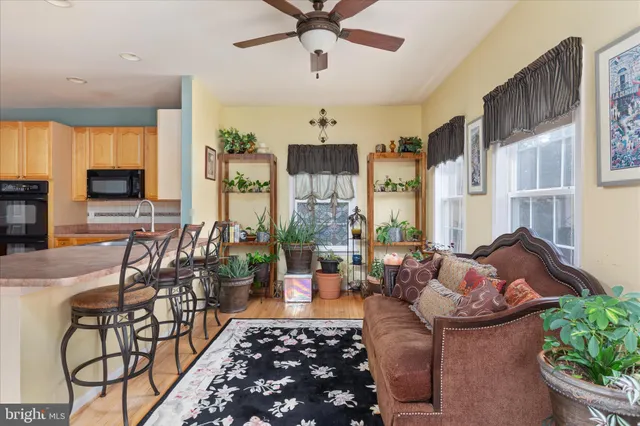 a living room with furniture a chandelier and a flat screen tv