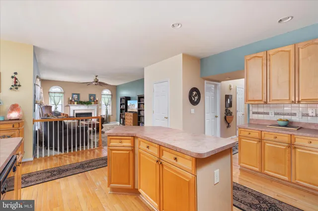 a kitchen with stainless steel appliances granite countertop a refrigerator a stove and a sink with cabinets