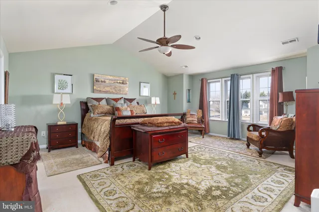 a bed sitting in a bedroom and dresser