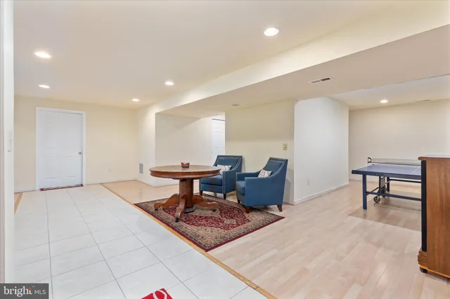 a view of a room with furniture and wooden floor
