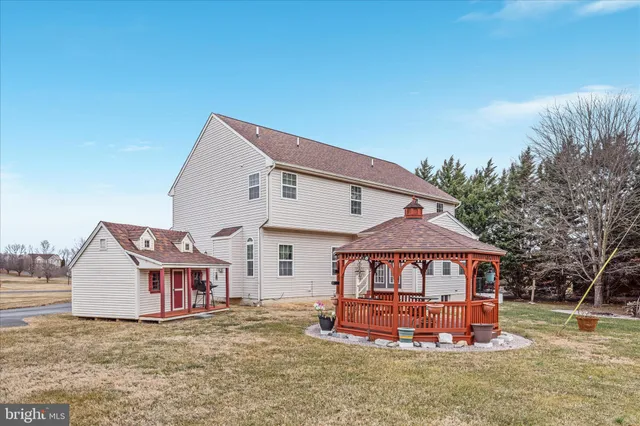 a view of a house with wooden fence