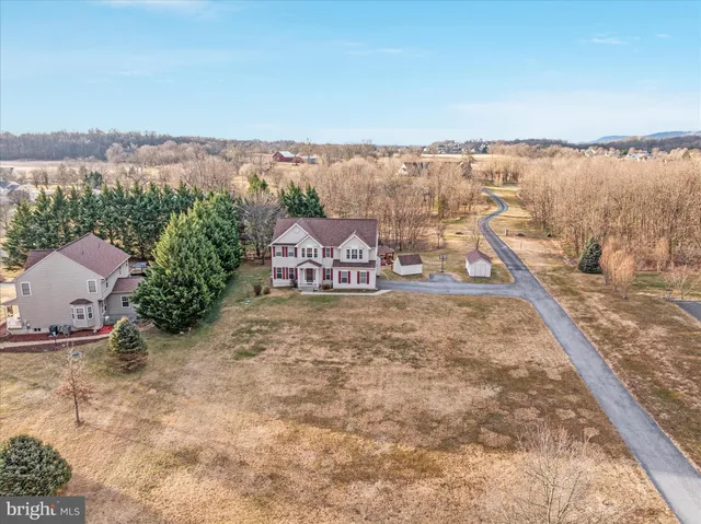 an aerial view of a house with garden space and ocean view