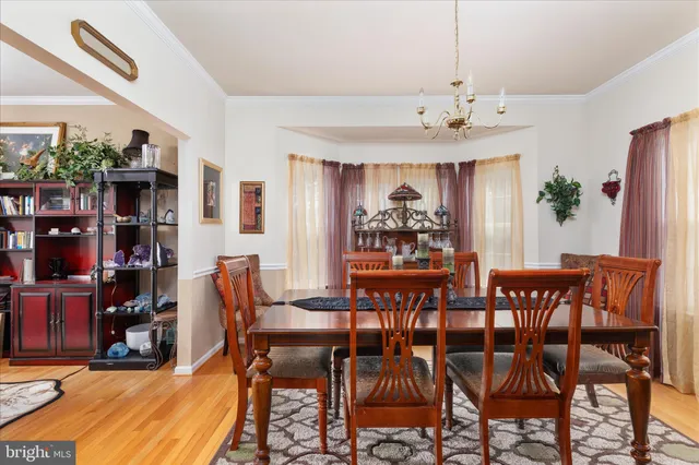 a view of a dining room with furniture and chandelier